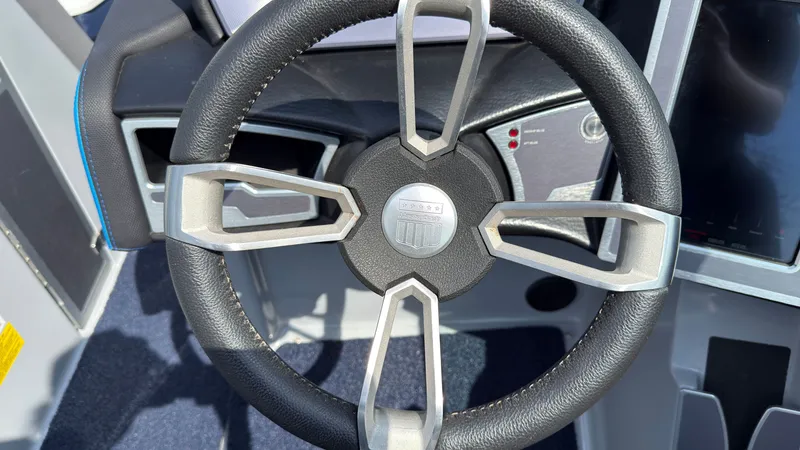 Slide: The Image of Steering wheel of a 2022 MasterCraft XT24 boat, close-up. - 26
