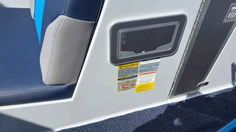 Slide: The Image of MasterCraft XT24 2022 boat seat with safety labels. - 31