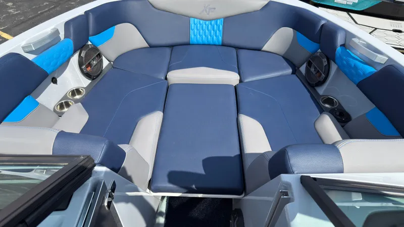 Slide: The Image of Interior of a 2022 MasterCraft XT24 boat with blue and gray seating. - 34