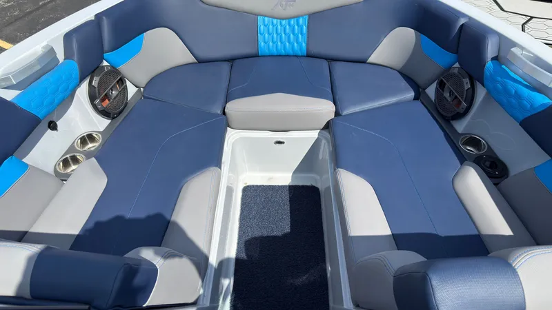 Slide: The Image of Interior of a 2022 MasterCraft XT24 boat with blue and gray seating. - 35