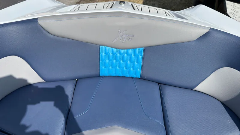 Slide: The Image of MasterCraft XT24 2022 boat seat with blue and gray upholstery. - 37