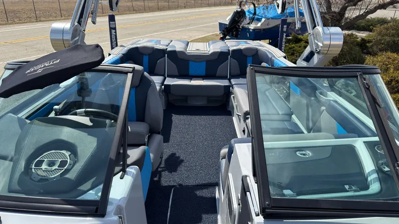 Slide: The Image of Interior of a 2022 MasterCraft XT24 boat with blue and gray seating. - 40
