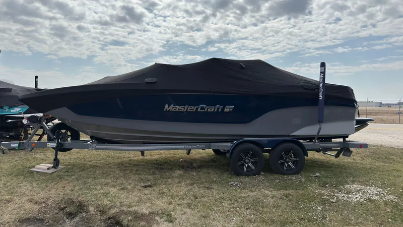 Slide: The Image of 2022 MasterCraft XT24 boat with cover on trailer. - 41