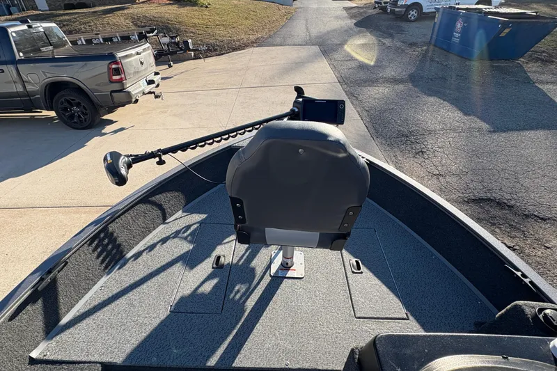 Slide: The Image of 2023 Lowe Fishing Machine 1675SC boat with trolling motor and seat on driveway. - 10