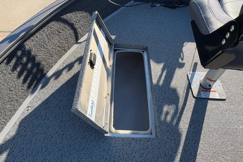 Slide: The Image of 2023 Lowe Fishing Machine 1675SC boat with open storage compartment and seat. - 12