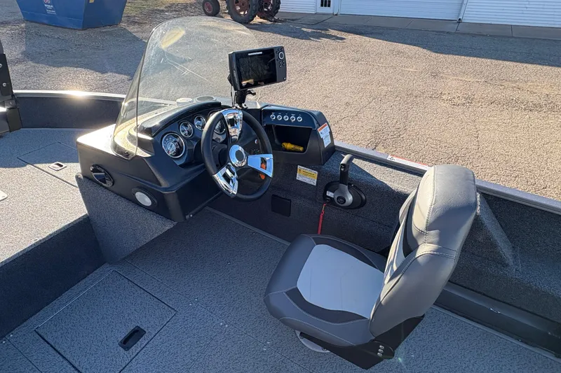 Slide: The Image of 2023 Lowe Fishing Machine 1675SC boat interior with steering console and seat. - 15