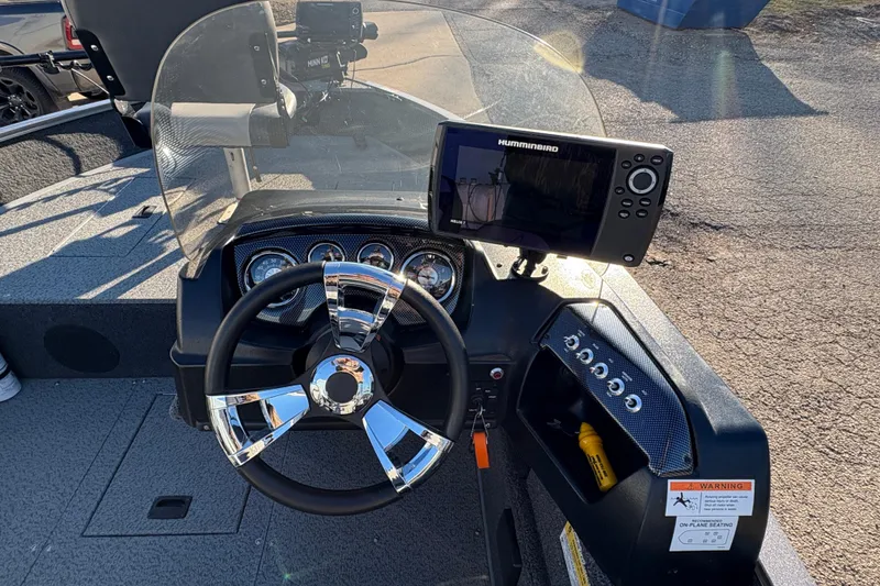 Slide: The Image of 2023 Lowe Fishing Machine 1675SC dashboard with steering wheel and Humminbird fish finder. - 16