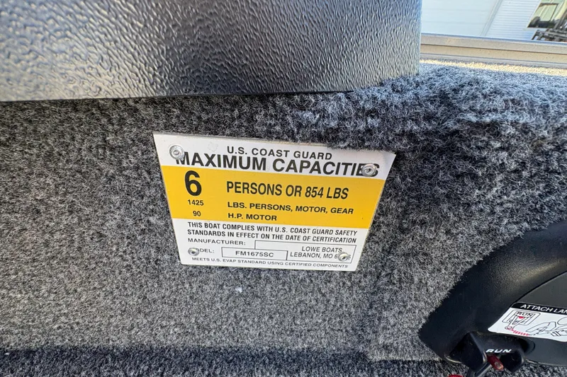 Slide: The Image of 2023 Lowe Fishing Machine 1675SC capacity label, 6 persons or 854 lbs, U.S. Coast Guard compliant. - 25