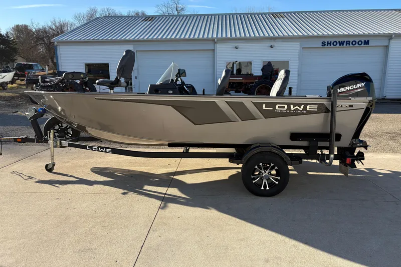 Slide: The Image of 2023 Lowe Fishing Machine 1675SC boat on trailer outside showroom. - 4