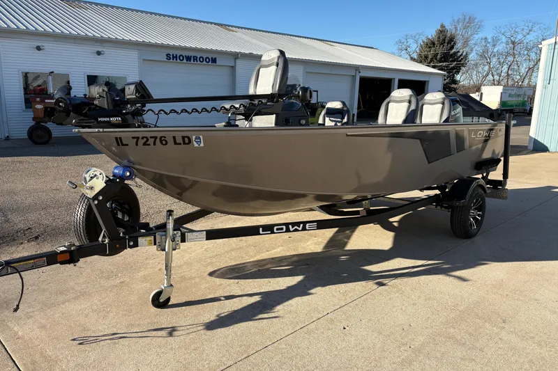 Slide: The Image of 2023 Lowe Fishing Machine 1675SC boat on trailer outside showroom. - 5
