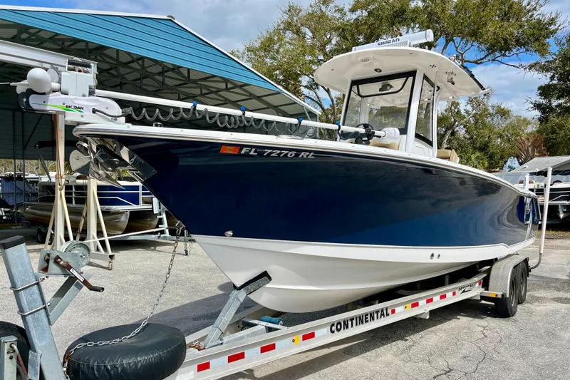 Slide: The Image of 2018 Sea Hunt Gamefish 27 Coffin Box boat on trailer, parked outdoors. - 0