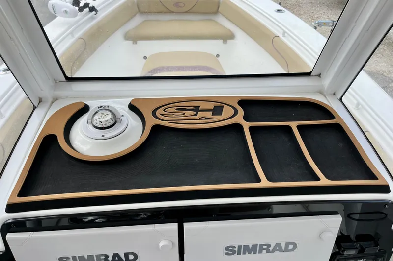 Slide: The Image of 2018 Sea Hunt Gamefish 27 Coffin Box dashboard with compass and storage compartments. - 10