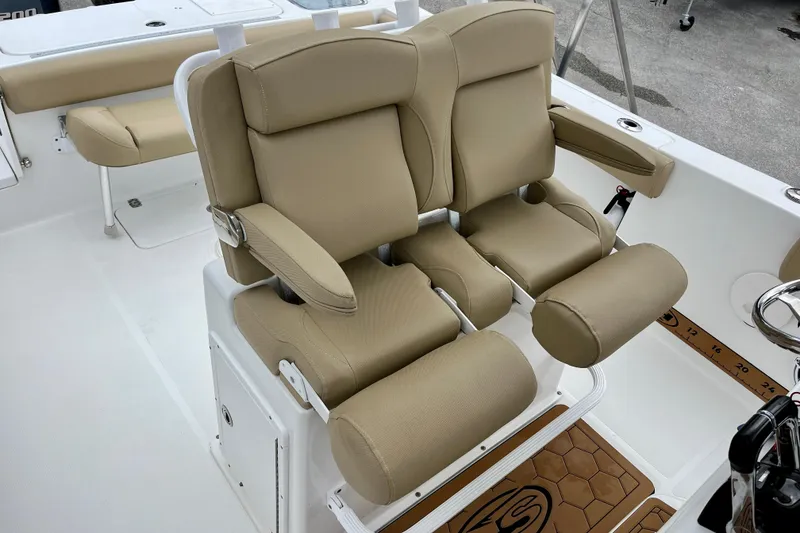 Slide: The Image of 2018 Sea Hunt Gamefish 27 Coffin Box boat with tan cushioned seating. - 16