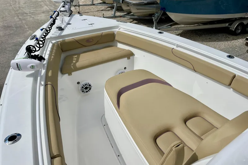 Slide: The Image of 2018 Sea Hunt Gamefish 27 Coffin Box interior with tan seating and white deck. - 28