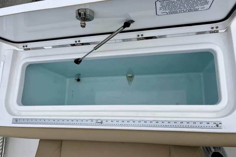Slide: The Image of Open coffin box on 2018 Sea Hunt Gamefish 27, featuring a measuring ruler. - 35