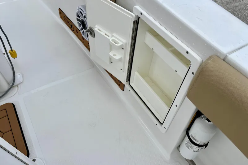 Slide: The Image of 2018 Sea Hunt Gamefish 27 Coffin Box interior with storage compartment and fire extinguisher. - 38