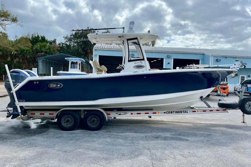 Slide: The Image of 2018 Sea Hunt Gamefish 27 Coffin Box boat on trailer, parked outdoors. - 5