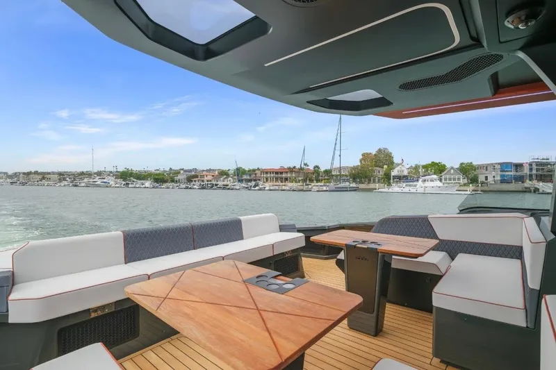 Slide: The Image of Luxurious 2025 Maori 64 yacht interior with elegant seating and scenic waterfront view. - 14