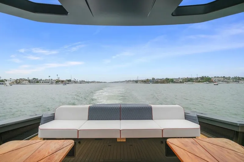 Slide: The Image of Luxurious seating on 2025 Maori 64 yacht, overlooking serene waters and distant shoreline. - 15