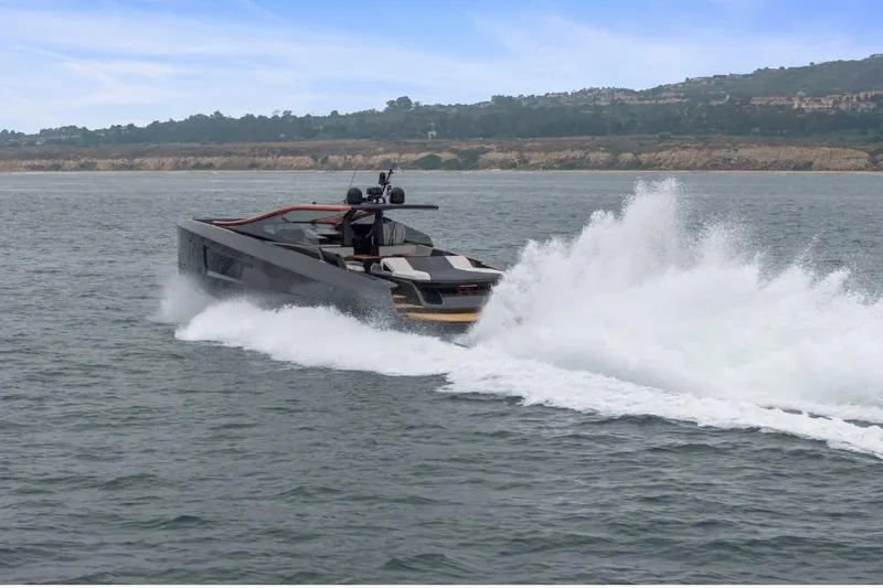 Slide: The Image of Sleek 2025 Maori 64 yacht cruising swiftly on open water. - 2