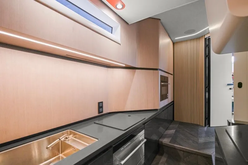 Slide: The Image of Modern kitchen interior in 2025 Maori 64 yacht, featuring sleek cabinetry and minimalist design. - 27