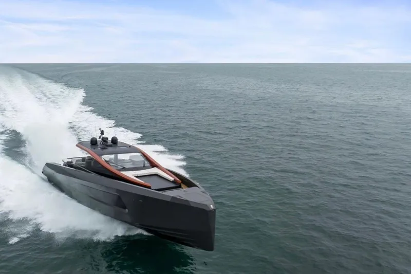 Slide: The Image of Sleek 2025 Maori 64 yacht cruising swiftly on open sea under clear skies. - 3
