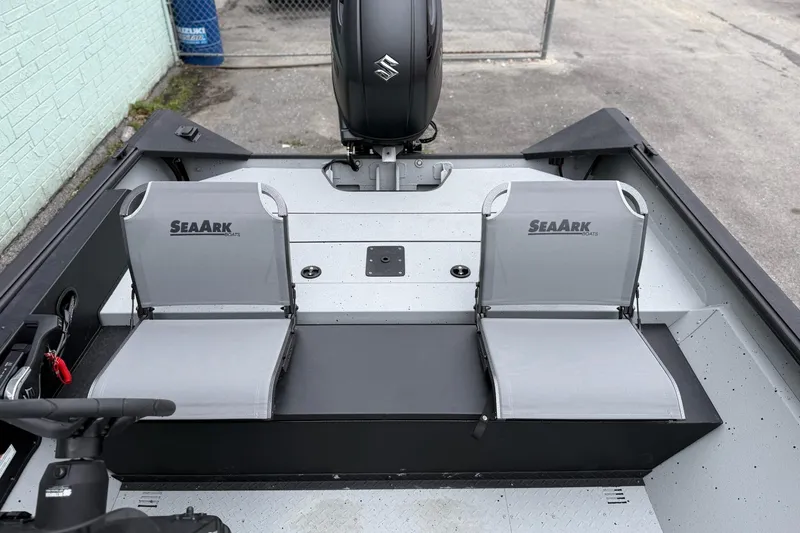 Slide: The Image of 2026 SeaArk Shadow 20 boat interior with dual seats and motor. - 10