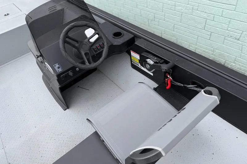 Slide: The Image of 2026 SeaArk Shadow 20 boat cockpit with steering wheel and controls. - 12