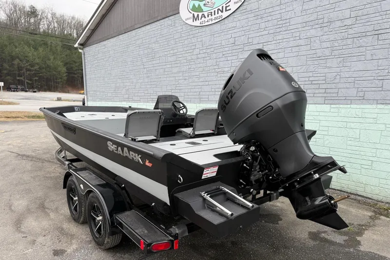 Slide: The Image of 2026 SeaArk Shadow 20 boat with Suzuki outboard motor on trailer, parked near a building. - 4
