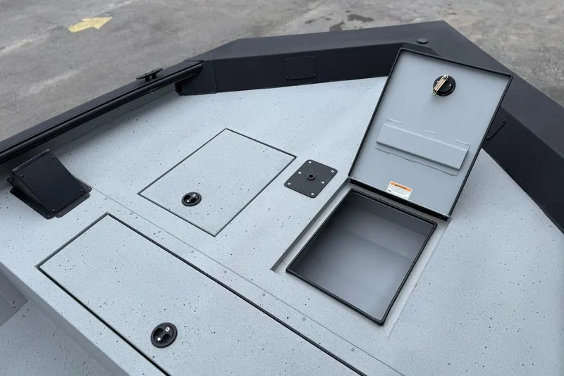 Slide: The Image of 2026 SeaArk Shadow 20 boat deck with storage compartments and open hatch. - 8