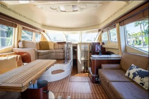 Slide: The Image of Luxurious interior of a 2005 Sea Ray 420 Sedan Bridge yacht with elegant seating and wood flooring. - 12