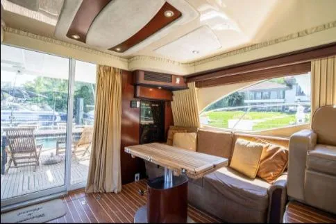 Slide: The Image of Interior of 2005 Sea Ray 420 Sedan Bridge yacht with elegant seating and wooden accents. - 14
