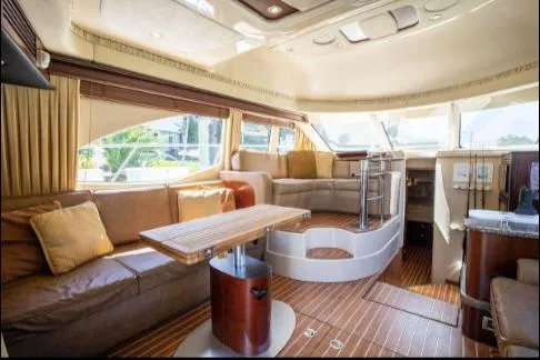 Slide: The Image of Luxurious interior of 2005 Sea Ray 420 Sedan Bridge yacht with elegant seating and wood flooring. - 15