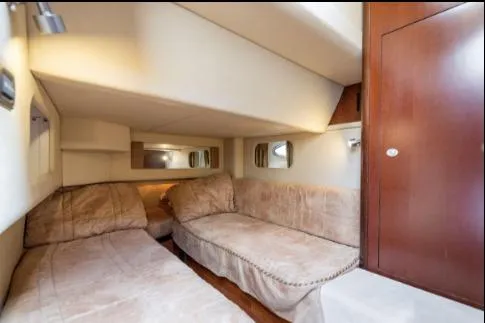 Slide: The Image of 2005 Sea Ray 420 Sedan Bridge cabin interior with twin beds and wooden cabinetry. - 19