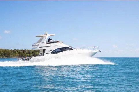 Slide: The Image of 2005 Sea Ray 420 Sedan Bridge cruising on clear blue water. - 4