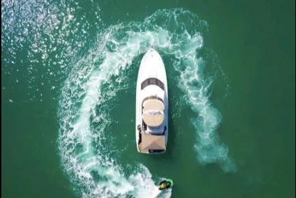 Slide: The Image of Aerial view of 2005 Sea Ray 420 Sedan Bridge with jet ski circling. - 5