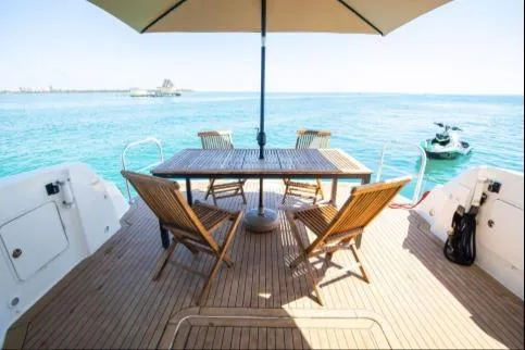 Slide: The Image of 2005 Sea Ray 420 Sedan Bridge yacht deck with chairs and table, ocean view. - 7