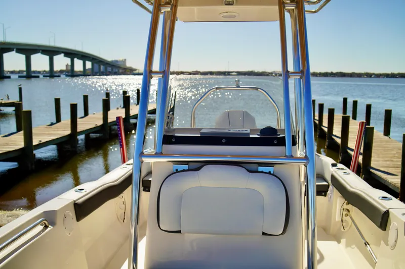 Slide: The Image of 2020 Key West 203 FS boat docked by a scenic waterfront with bridge view. - 10
