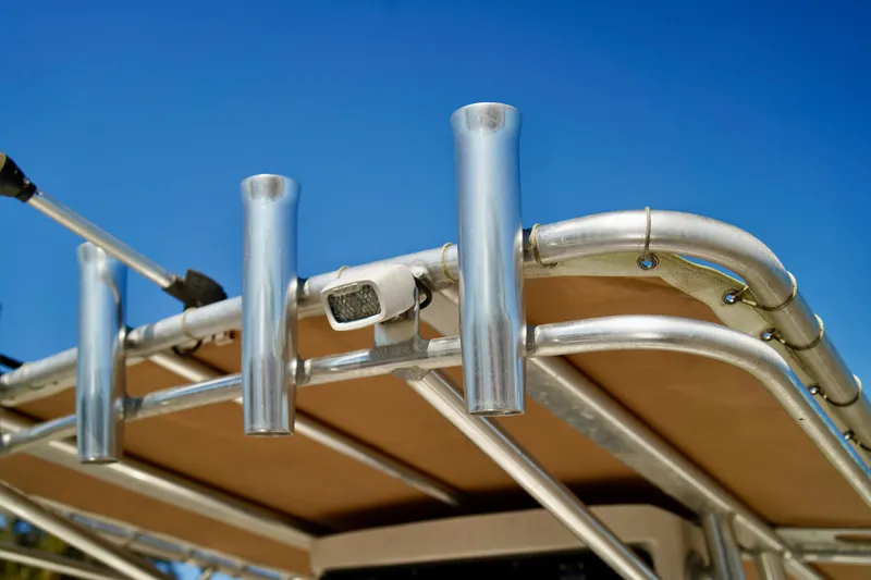 Slide: The Image of Aluminum rod holders on 2020 Key West 203 FS boat against clear blue sky. - 11