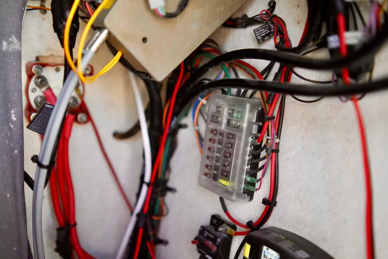 Slide: The Image of Electrical wiring and fuse box inside a 2020 Key West 203 FS boat. - 15