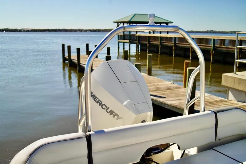 Slide: The Image of 2020 Key West 203 FS boat with Mercury engine docked by a wooden pier. - 19