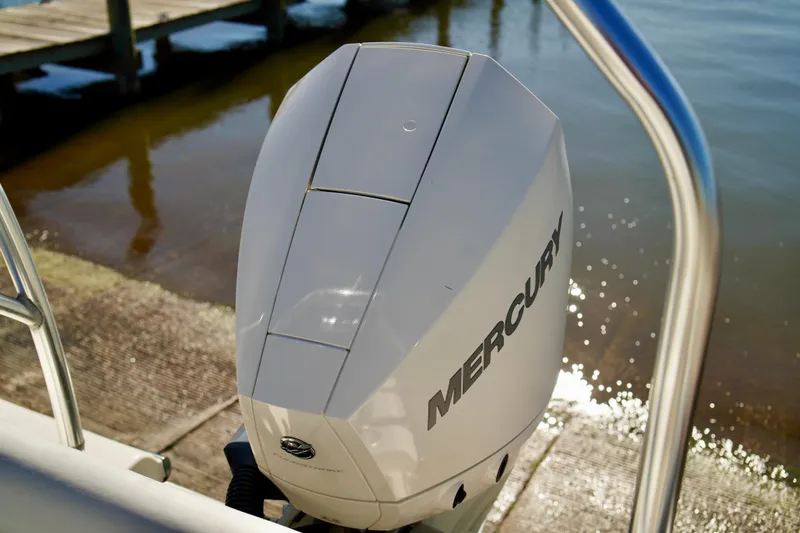 Slide: The Image of Mercury outboard motor on 2020 Key West 203 FS boat by the water. - 20