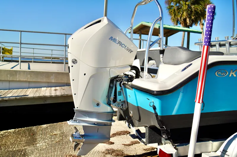 Slide: The Image of 2020 Key West 203 FS boat with Mercury outboard motor, docked under clear blue sky. - 21