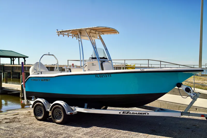 Slide: The Image of 2020 Key West 203 FS boat on trailer at dockside under clear blue sky. - 3