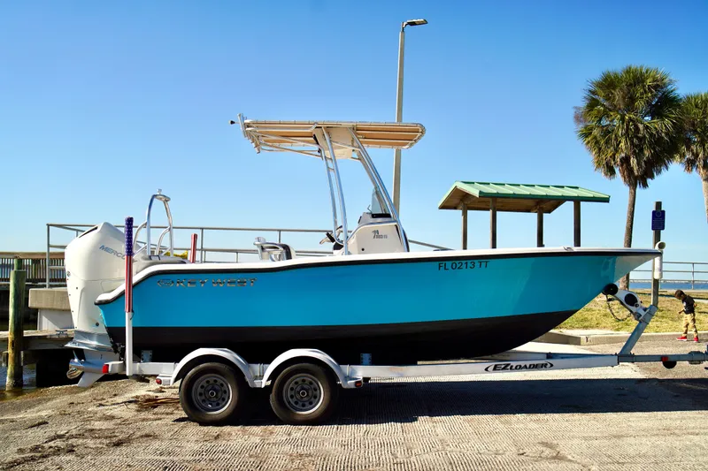 Slide: The Image of 2020 Key West 203 FS boat on trailer at a sunny dockside location. - 4