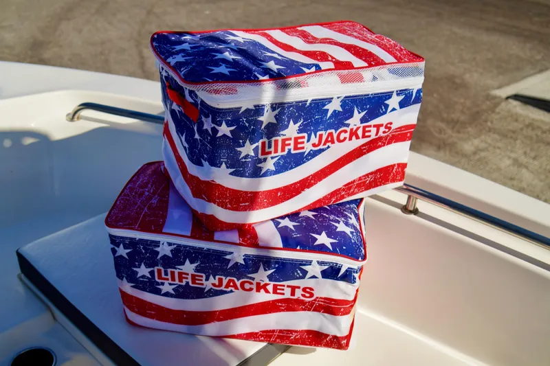 Slide: The Image of American flag-themed life jacket bags on a 2020 Key West 203 FS boat. - 6