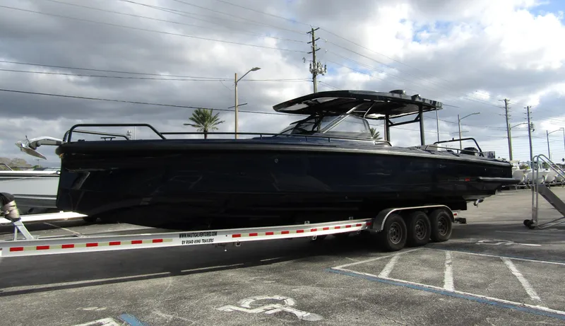 Slide: The Image of 2024 BRABUS Shadow 900 ST boat on trailer, parked outdoors under cloudy sky. - 3