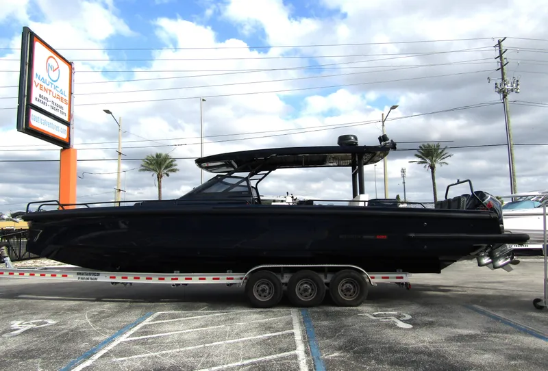 Slide: The Image of 2024 BRABUS Shadow 900 ST boat on trailer, parked outdoors under cloudy sky. - 0