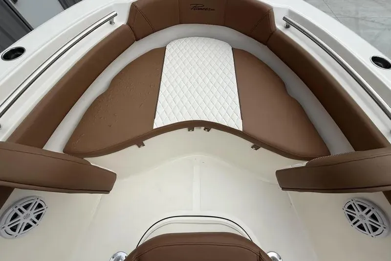Slide: The Image of 2026 Pioneer 202 Islander boat interior with brown and white cushioned seating. - 10