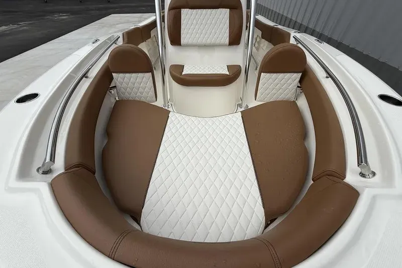 Slide: The Image of 2026 Pioneer 202 Islander boat interior with brown and white cushioned seating. - 11